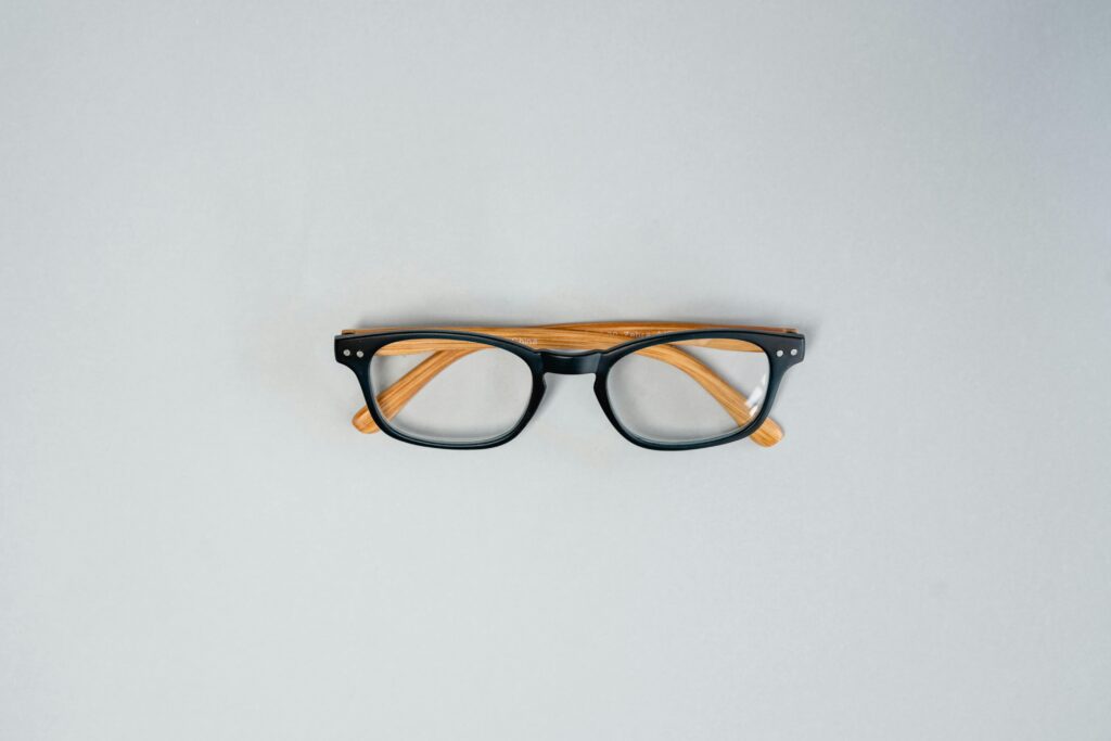 A Pair of Eyeglasses on a White Surface
